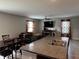 Open-concept area showcasing a kitchen island, dining set, and a cozy living room with a ceiling fan at 14812 Boulder Pass Pl, Wimauma, FL 33598