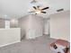 Loft area featuring neutral carpeting and a ceiling fan at 14812 Boulder Pass Pl, Wimauma, FL 33598