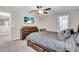The main bedroom features a ceiling fan and neutral carpeting at 14812 Boulder Pass Pl, Wimauma, FL 33598