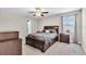 The main bedroom offers neutral carpeting and furniture at 14812 Boulder Pass Pl, Wimauma, FL 33598
