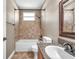 Tiled bathroom featuring a shower and bath combo with granite counters, and decorative framed mirror at 15714 Ibisridge Dr, Lithia, FL 33547