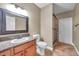 Bathroom with tile flooring, granite counters, a tiled walk-in shower with glass doors, and decorative framed mirror at 15714 Ibisridge Dr, Lithia, FL 33547