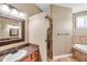 Bathroom featuring granite counter tops, a walk in shower and a soaking tub with tile surround at 15714 Ibisridge Dr, Lithia, FL 33547