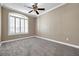 Neutral bedroom with new carpet, ceiling fan, white trim, and a bright window at 15714 Ibisridge Dr, Lithia, FL 33547