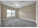Neutral bedroom with new carpet, ceiling fan, white trim, and a window at 15714 Ibisridge Dr, Lithia, FL 33547