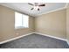 Bedroom features carpeted floors, a neutral color scheme, ceiling fan and a window at 15714 Ibisridge Dr, Lithia, FL 33547
