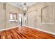 Elegant dining room with hardwood floors, chandelier, neutral paint, and decorative archways leading to the kitchen at 15714 Ibisridge Dr, Lithia, FL 33547