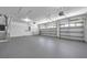 Spacious garage with neutral paint, bright lighting, and multiple bays for parking at 15714 Ibisridge Dr, Lithia, FL 33547
