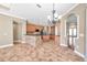 Open kitchen area boasts granite countertops, tile flooring, island, and an archway to the dining and living areas at 15714 Ibisridge Dr, Lithia, FL 33547