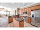 Bright kitchen features granite counters, stainless appliances, central island and adjoining living area at 15714 Ibisridge Dr, Lithia, FL 33547