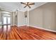 Spacious living room showcasing hardwood floors, neutral paint, crown molding, and double-door entryway at 15714 Ibisridge Dr, Lithia, FL 33547