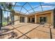 Spacious screened-in patio featuring concrete flooring, ceiling fans, and ample space for outdoor activities at 15714 Ibisridge Dr, Lithia, FL 33547