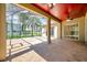 Screened-in patio with a patterned concrete floor and ceiling fans for outdoor comfort and leisure at 15714 Ibisridge Dr, Lithia, FL 33547