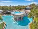 Aerial view of a unique community pool featuring a multi-tiered waterfall and lush landscaping at 15714 Ibisridge Dr, Lithia, FL 33547