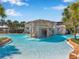 Resort-style pool with waterfall feature, palm trees, and inviting turquoise water at 15714 Ibisridge Dr, Lithia, FL 33547