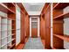 Huge walk-in closet with custom wood shelving and drawers for optimal storage solutions at 15714 Ibisridge Dr, Lithia, FL 33547
