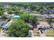 An aerial view showing the neighborhood with well-maintained homes, mature trees and the nearby ocean at 16039 Frost Dr, Hudson, FL 34667