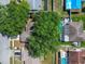 A birds eye view of neighboring homes that have private pools, lush trees, and a shared street at 16039 Frost Dr, Hudson, FL 34667