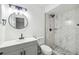Modern bathroom featuring marble tiled shower, updated vanity, and stylish fixtures at 16039 Frost Dr, Hudson, FL 34667