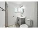 Bright bathroom featuring tile floors, modern vanity, round mirror and updated fixtures at 16039 Frost Dr, Hudson, FL 34667
