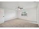 Bright bedroom with ceiling fan, carpet, and a window for natural light at 16039 Frost Dr, Hudson, FL 34667