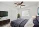 This bedroom offers ample closet space, ceiling fan, and bright, natural light at 16039 Frost Dr, Hudson, FL 34667