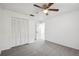 This carpeted bedroom has a ceiling fan and access to an ensuite bathroom at 16039 Frost Dr, Hudson, FL 34667