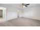 This bedroom features neutral carpeting and access to an ensuite bathroom at 16039 Frost Dr, Hudson, FL 34667