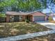 Single-story home featuring a neutral exterior, well-kept lawn, and a convenient two-car garage at 16039 Frost Dr, Hudson, FL 34667