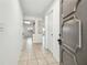 Bright foyer featuring tile flooring, neutral walls, and an open view to the kitchen and living area at 16039 Frost Dr, Hudson, FL 34667