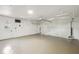 Spacious garage with white walls, concrete flooring, and a functional garage door at 16039 Frost Dr, Hudson, FL 34667