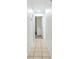 Clean hallway with tile flooring leading to additional rooms in the home at 16039 Frost Dr, Hudson, FL 34667
