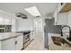 Bright kitchen featuring granite countertops, stainless appliances, and stylish cabinetry at 16039 Frost Dr, Hudson, FL 34667