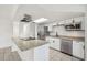 Stylish kitchen featuring granite countertops, stainless steel appliances, and tile flooring at 16039 Frost Dr, Hudson, FL 34667