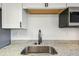 Close-up on the kitchen sink and granite countertop with stainless steel appliances at 16039 Frost Dr, Hudson, FL 34667