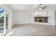 Bright and airy living room with tile flooring and fireplace, leading to outdoor views at 16039 Frost Dr, Hudson, FL 34667