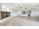 Open floor plan with tile flooring, stone fireplace, and kitchen featuring stainless appliances at 16039 Frost Dr, Hudson, FL 34667