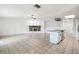 Bright living area features tile flooring, fireplace, and flows into an open kitchen at 16039 Frost Dr, Hudson, FL 34667