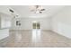 Open living room features tile floors and sliding glass doors to outdoor living space at 16039 Frost Dr, Hudson, FL 34667