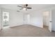 Spacious main bedroom with carpet and ceiling fan, featuring ensuite bath and walk-in closet at 16039 Frost Dr, Hudson, FL 34667
