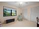 Inviting bedroom with a large window, comfortable armchair, and ample closet space at 1800 Salem Ct, Dunedin, FL 34698