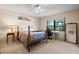 Bright bedroom featuring a ceiling fan, large window with a view, and a dedicated workspace at 1800 Salem Ct, Dunedin, FL 34698