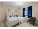 Charming bedroom with twin beds and a cozy armchair, creating a comfortable and inviting space at 1800 Salem Ct, Dunedin, FL 34698