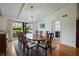 Traditional dining room features a wood table and large window with a view of the landscaped yard at 1800 Salem Ct, Dunedin, FL 34698