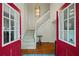Bright foyer with hardwood floors, staircase, and a stylish light fixture at 1800 Salem Ct, Dunedin, FL 34698