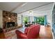 Warm living room features a stone fireplace, hardwood floors, and comfortable seating at 1800 Salem Ct, Dunedin, FL 34698