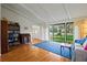 Bright living room with hardwood floors, large windows, and vaulted ceilings bring in natural light at 1800 Salem Ct, Dunedin, FL 34698