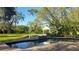 Backyard pool and gazebo with brick pavers and mature landscaping creating a private oasis at 1800 Salem Ct, Dunedin, FL 34698