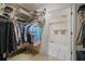 Functional walk-in closet with organized shelving and storage solutions, connecting to a modern bathroom at 1800 Salem Ct, Dunedin, FL 34698