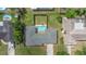 Aerial view of home featuring a backyard pool with an adjacent landscaped area enclosed by a wood fence at 1881 Stancel Dr, Clearwater, FL 33764